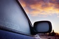 Car window and side mirror covered with ice in the Royalty Free Stock Photo