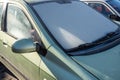 Car windscreen frozen at low temperature in morning, requiring defrosting, cleaning, removing ice Royalty Free Stock Photo