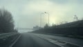 Driving up slip road joining M60 motorway in winter fog.