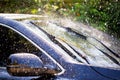 Car windshield with rain drops and frameless wiper blade Royalty Free Stock Photo