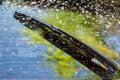 Car windshield with rain drops and frameless wiper blade