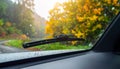 Generated image Car windshield with rain drops and frameless wiper blade closeup Royalty Free Stock Photo