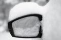 Car wing mirror close up, snowcapped in black and white