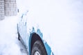 Car winter emergency. Weather-related vehicle emergencies. Automobile covered with snow in the winter blizzard. Frozen, snow