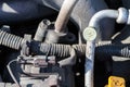 Car wiring, hoses and air conditioning duct. Dusty details of a flat-four boxer car engine compartment under the open hood