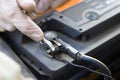 Car workshop. Car service. The mechanic unscrews the battery clutch from the battery in the car Royalty Free Stock Photo