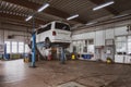 In car workshop there are lifting platforms for repairing cars