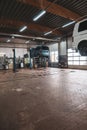 In car workshop there are lifting platforms for repairing cars