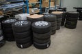 In car workshop there are many stacked car tires