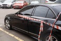 A car is wrapped in safety tapes.