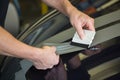 Car wrapper straightening foil with a squeegee Royalty Free Stock Photo