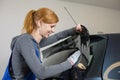 Car wrappers tinting a vehicle window with a tinted foil or film