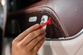 Car wrapping process, close up of man putting interior car protective film on car door Royalty Free Stock Photo