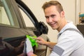 Car wrapping specialist cutting adhesive foil or film with a box cutter