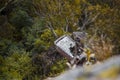 Car wreckage at bottom of hill in national park forest