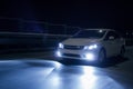 Car with xenon headlights fast drive on road at nigh Royalty Free Stock Photo