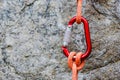 Carabiner with rope on rocky background Royalty Free Stock Photo