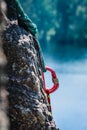 Carabiner between two ropes on a rock