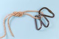 Carabiners in rope knot ÃÂ°igure-eight loop on blue background