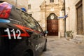 Carabinieri car with the emergency number 112 in the foreground and in the background the police station of Monopoli Puglia-Italy