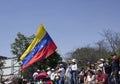 A Venezuelan holds flag as oppositions march during a protest against Maduro government in support to Juan Guaido in Caracas