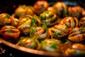 Caracoles a la Llauna - Grilled snails seasoned with garlic, parsley, and olive oil