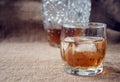Carafe and glass of whisky, whiskey bourbon on a burlap, sacks background Royalty Free Stock Photo