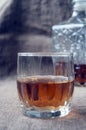 Carafe and glass of whisky, whiskey bourbon on a burlap, sacks background Royalty Free Stock Photo