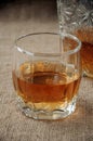 Carafe and glass of whisky, whiskey bourbon on a burlap, sacks background Royalty Free Stock Photo