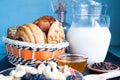 Carafe of milk with baked peanut butter cookies