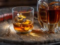 Carafe of whisky and glass of whisky on old wooden cask at the dark background Royalty Free Stock Photo