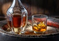 Carafe of whisky and glass of whisky on old wooden cask at the dark background Royalty Free Stock Photo