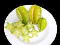 Carambola or Star apple fruit, slice of carambola fruit or star apple fruit on white dish.