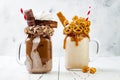 Caramel and chocolate crazy freakshake, milkshakes with brezel waffles, popcorn, marshmallow, ice cream and whipped cream.