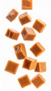 Caramel Cubes Falling on White Background for Sweet Treat Concept Royalty Free Stock Photo