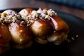 Caramel Eclairs with Hazelnut and cream in black plate.