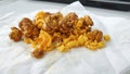 Caramel-flavored popcorn snacks on a tissue at the table Royalty Free Stock Photo