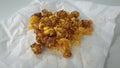 Caramel-flavored popcorn snacks on a tissue at the table Royalty Free Stock Photo