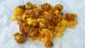 Caramel-flavored popcorn snacks on a tissue at the table Royalty Free Stock Photo