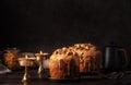 Caramel glazed Easter cakes decorated with nuts on dark background.