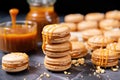caramel macarons with whole and cut caramel candies nearby