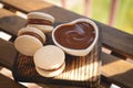 Caramel Macaroons with salted caramel on wooden background Royalty Free Stock Photo