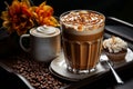 A caramel macchiato in a glass, served on a tray with coffee beans, a creamer, and a cupcake