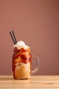 Caramel milkshake with coffee on wooden table. Salted caramel ice cream sundae. Cold coffee drink frappe frappuccino , with Royalty Free Stock Photo
