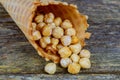 Caramel nut in sugar cones on wood