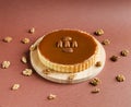 Caramel nuts tartlet with pecan nuts on wood board
