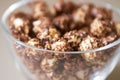 Caramel pop corn. Light background. Glass plate