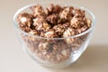 Caramel pop corn. Light background. Glass plate Royalty Free Stock Photo