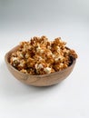 Caramel popcorn in a bowl on white background