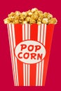 Caramel popcorn in a decorative paper popcorn cup Royalty Free Stock Photo